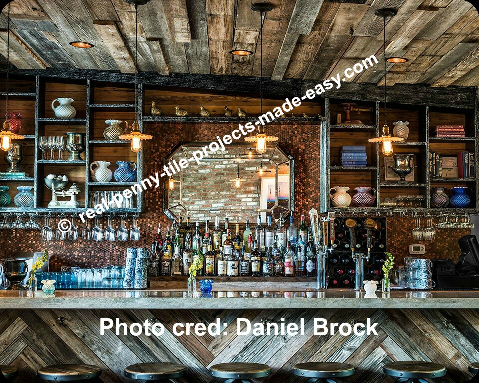 Bar wall / backsplash gets lots of pennies installed for the best rustic/antique look together with the decor.