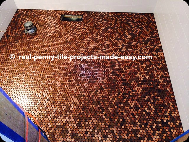 Handmade sheets of real pennies installed on bathroom floor as the ultimate penny round mosaic tile.