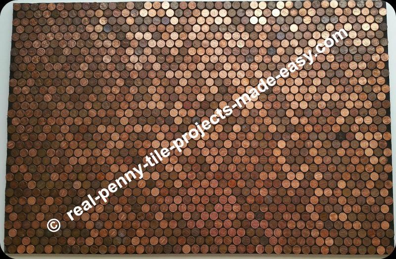 Black sanded grout applied to pennies as tile.
