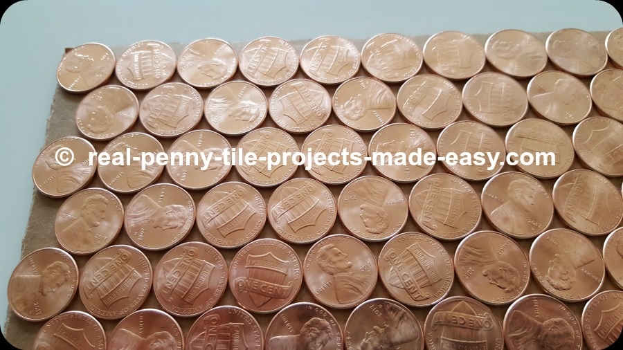 Close-up on offset/staggered rows of pennies also pointing to smaller empty room in between them.