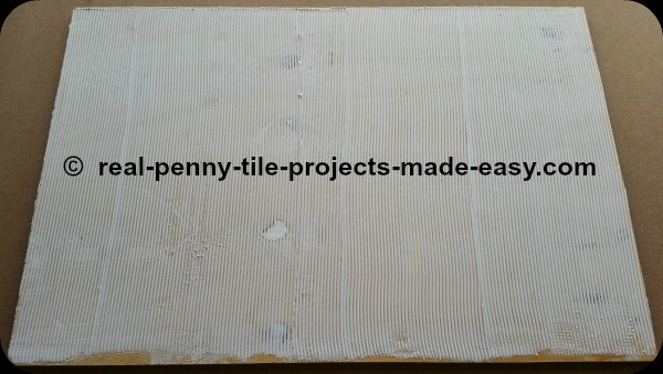 Glue spread over plywood to set pennies on floor.