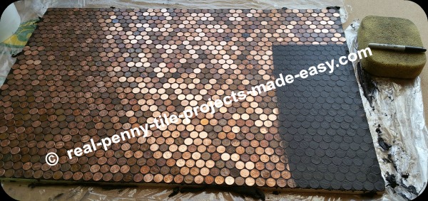 Grout application and cleaning of pennies on floor.
