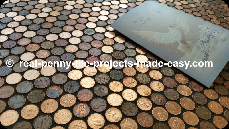 Copper/zinc coin - real pennies covering a floor, grouted with black sanded grout.
