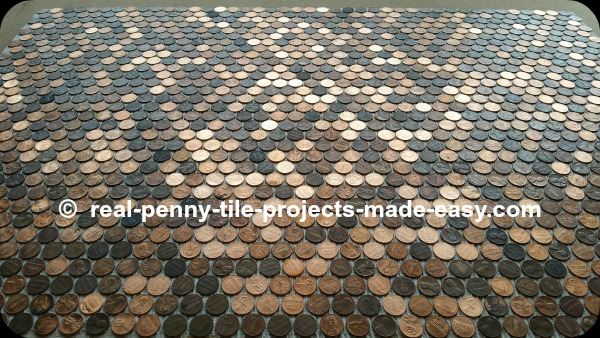 Pennies glued to floor, not grouted yet.