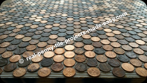 Six sheets of pennies glued to floor with adhesive.