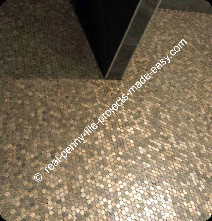 Floor covered in tile sheets of pennies. Picture taken before grouting.