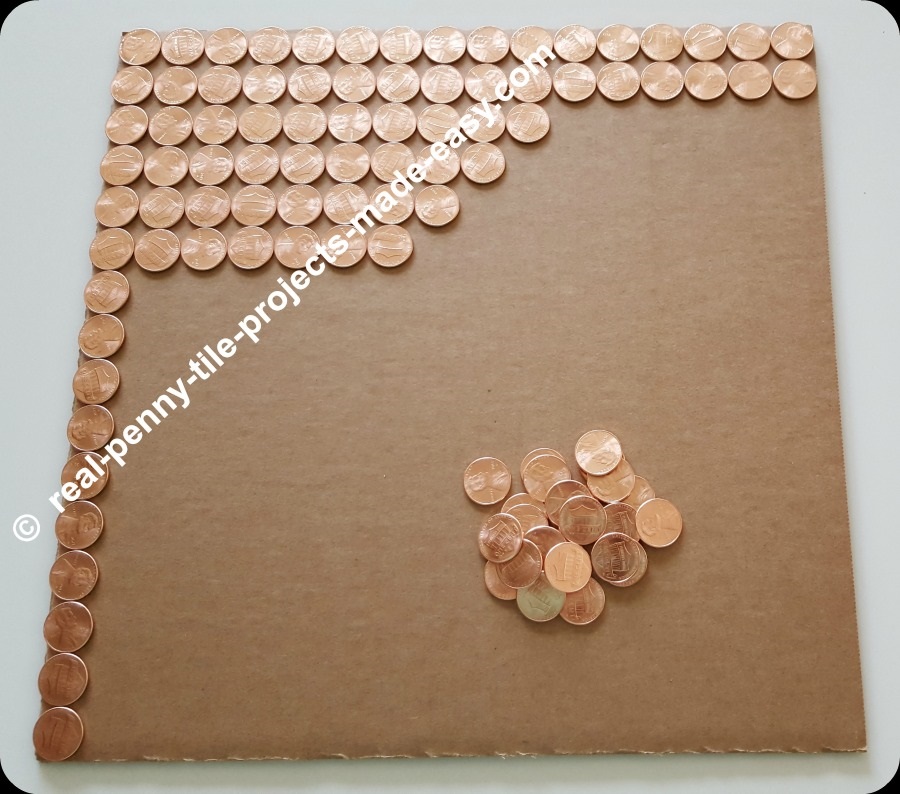 Filling up a square foot area with brand new shiny uncirculated pennies.