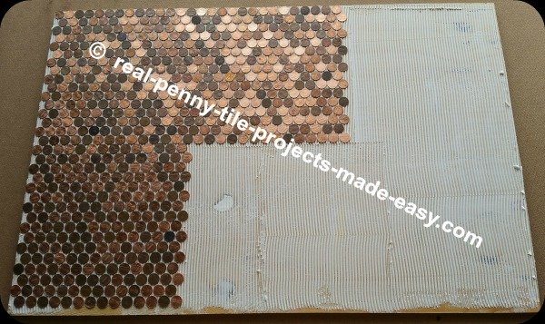 Sheets of pennies being installed on floor with adhesive.