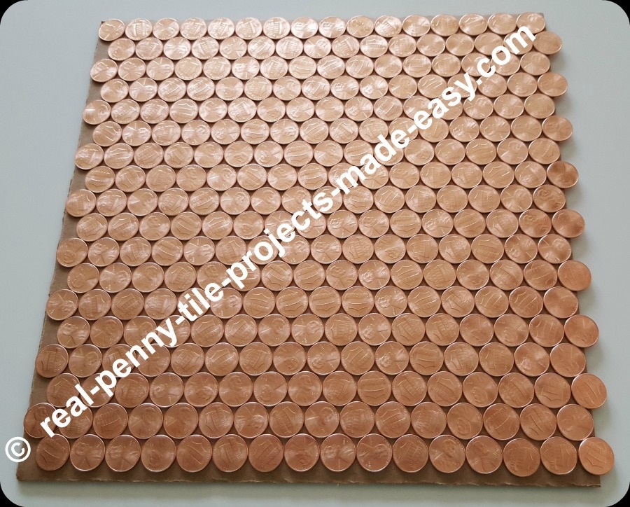18 offset rows of 16 pennies each can fit in 1 SF plus extra room left.