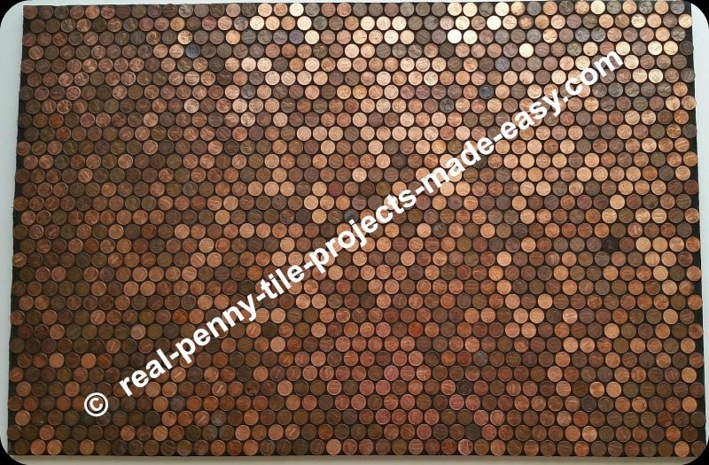 Black sanded grout applied to pennies as tile.
