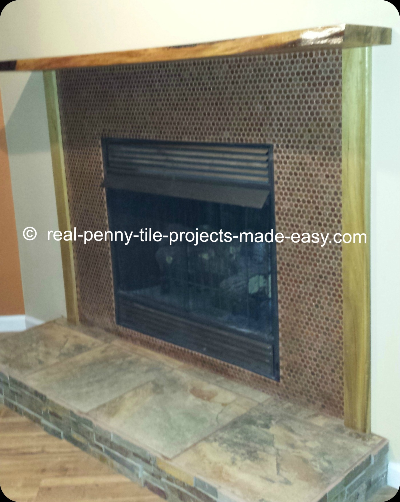 Real penny tile sheets installed on fireplace.