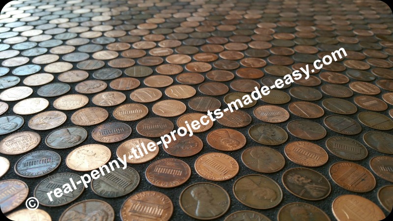 1 cent coins glued to floor, grouted in black.