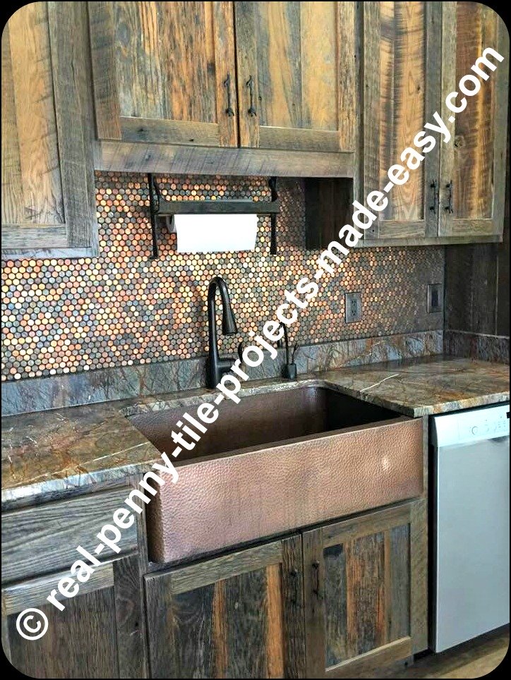 Rustic kitchen decor with real pennies on backsplash, antique looking cabinets, copper sink, dark faucet, matching theme countertops and other rustic characteristics.