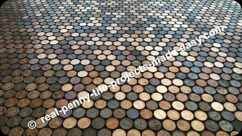 Grout on floor covered in pennies.