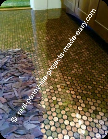 Bathroom floor covered with standard sheets of pennies made with random old and new pennies.
